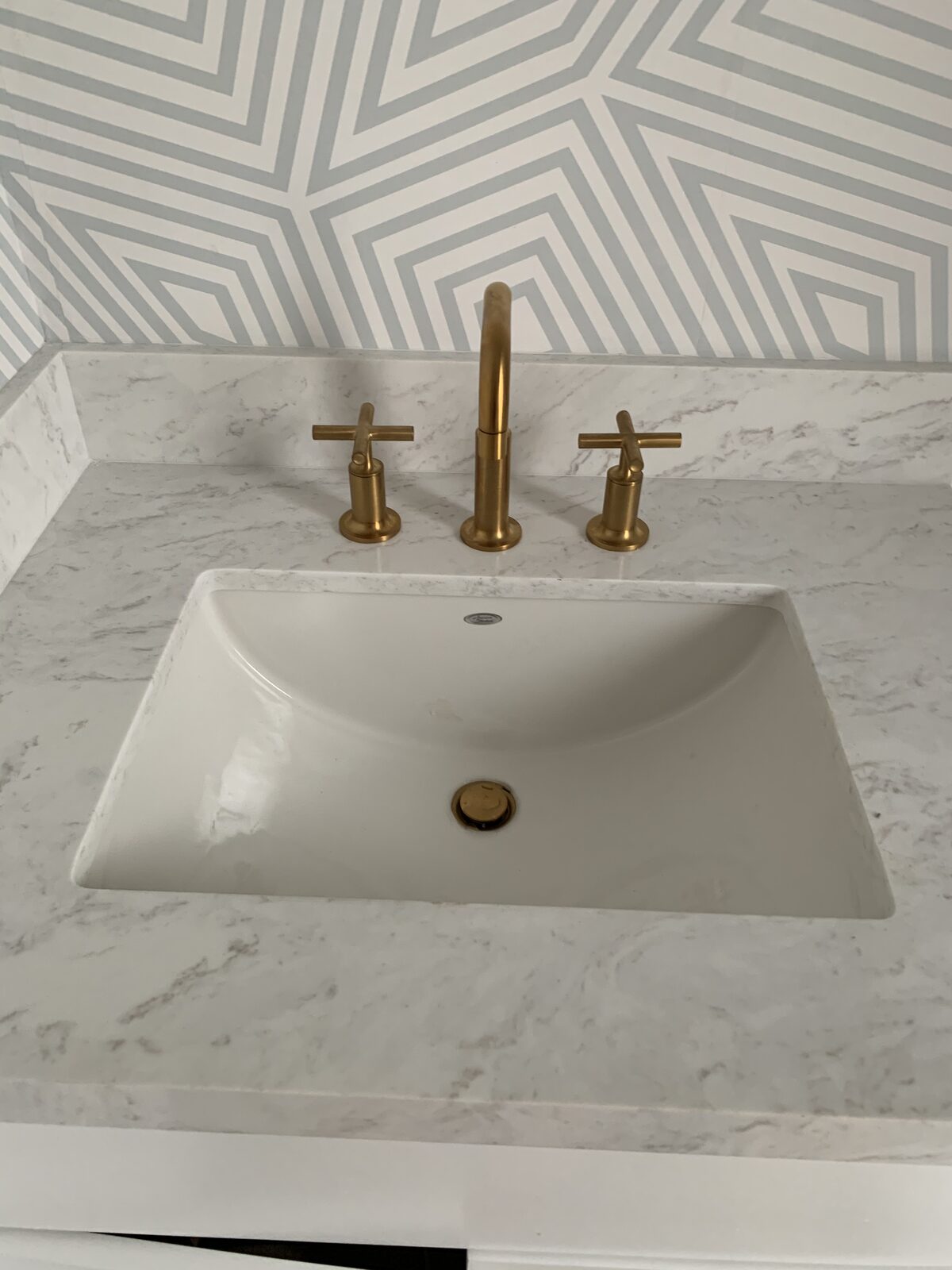 Brass faucet detail on marble vanity