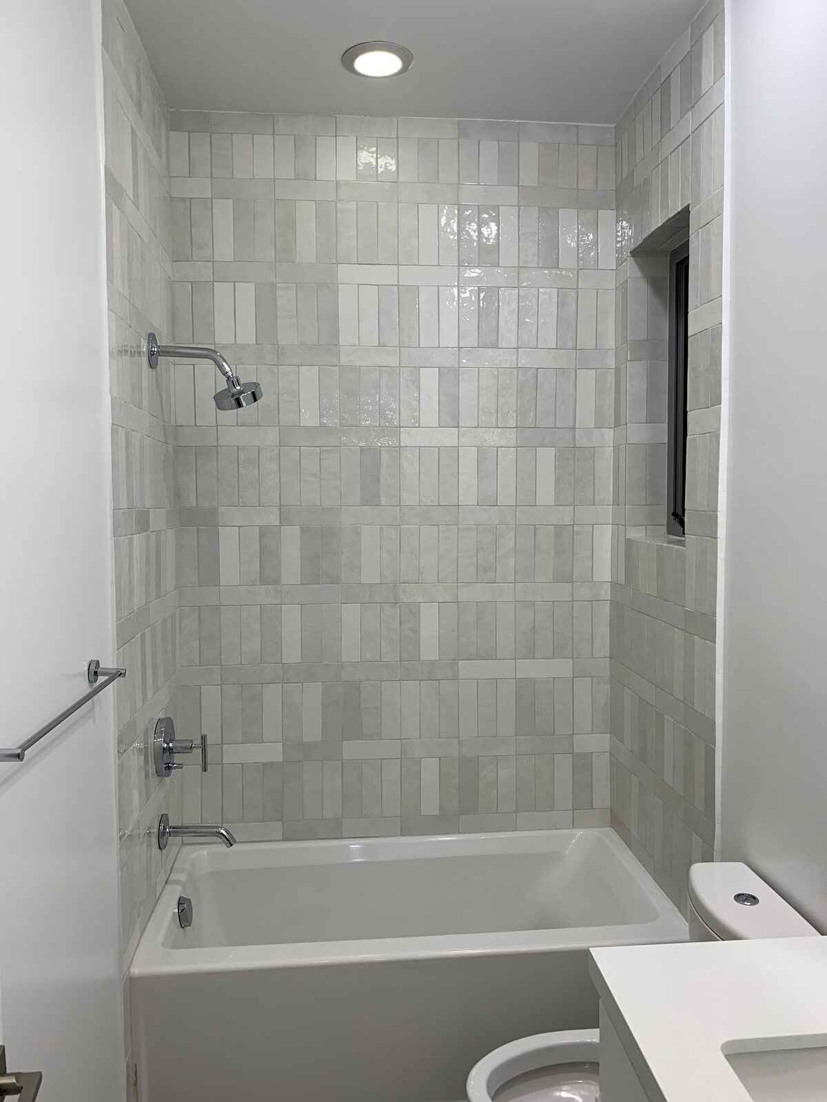 Clean subway tile shower and bathtub
