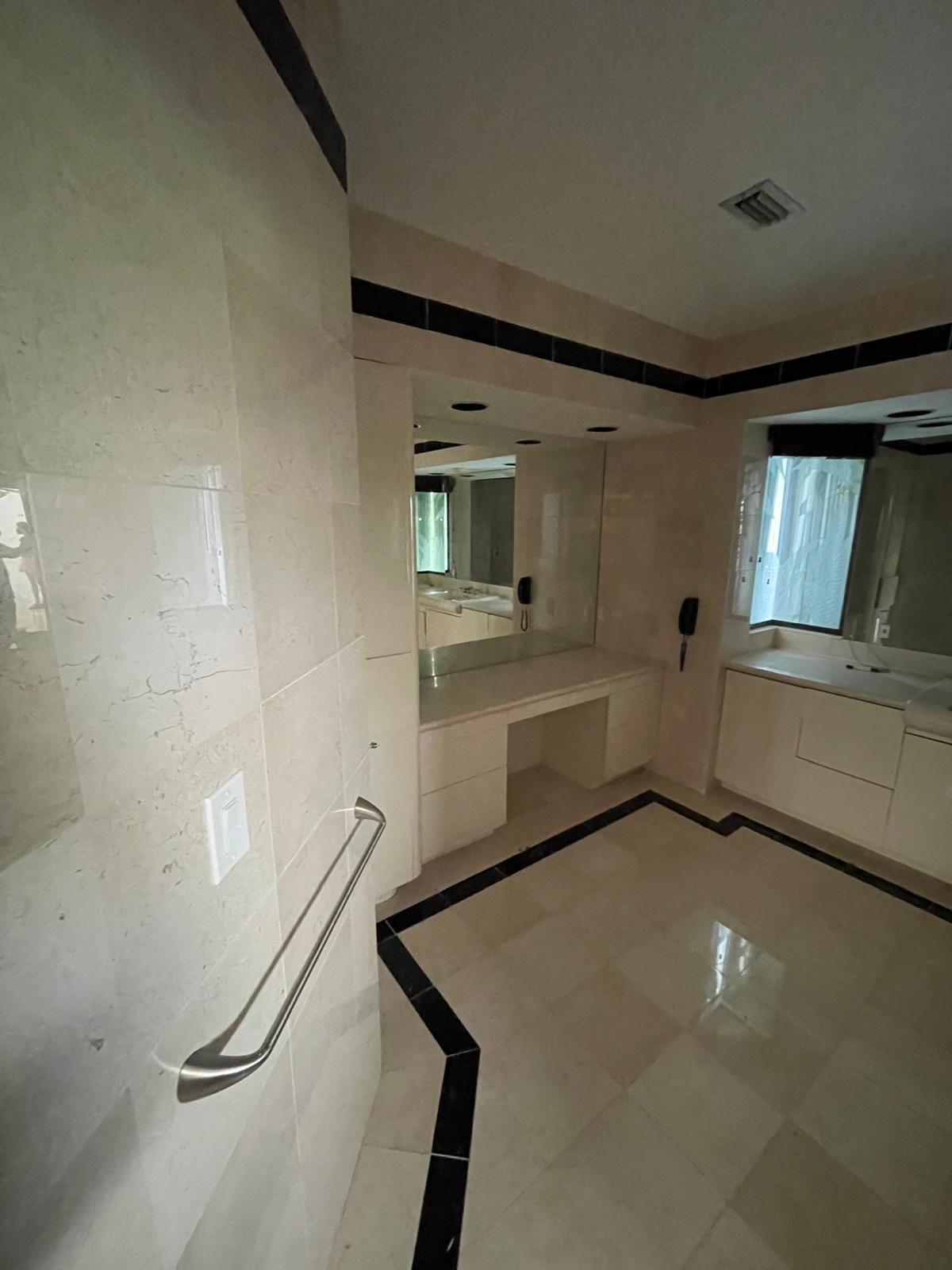 Luxury bathroom with teal tile and brass fixtures