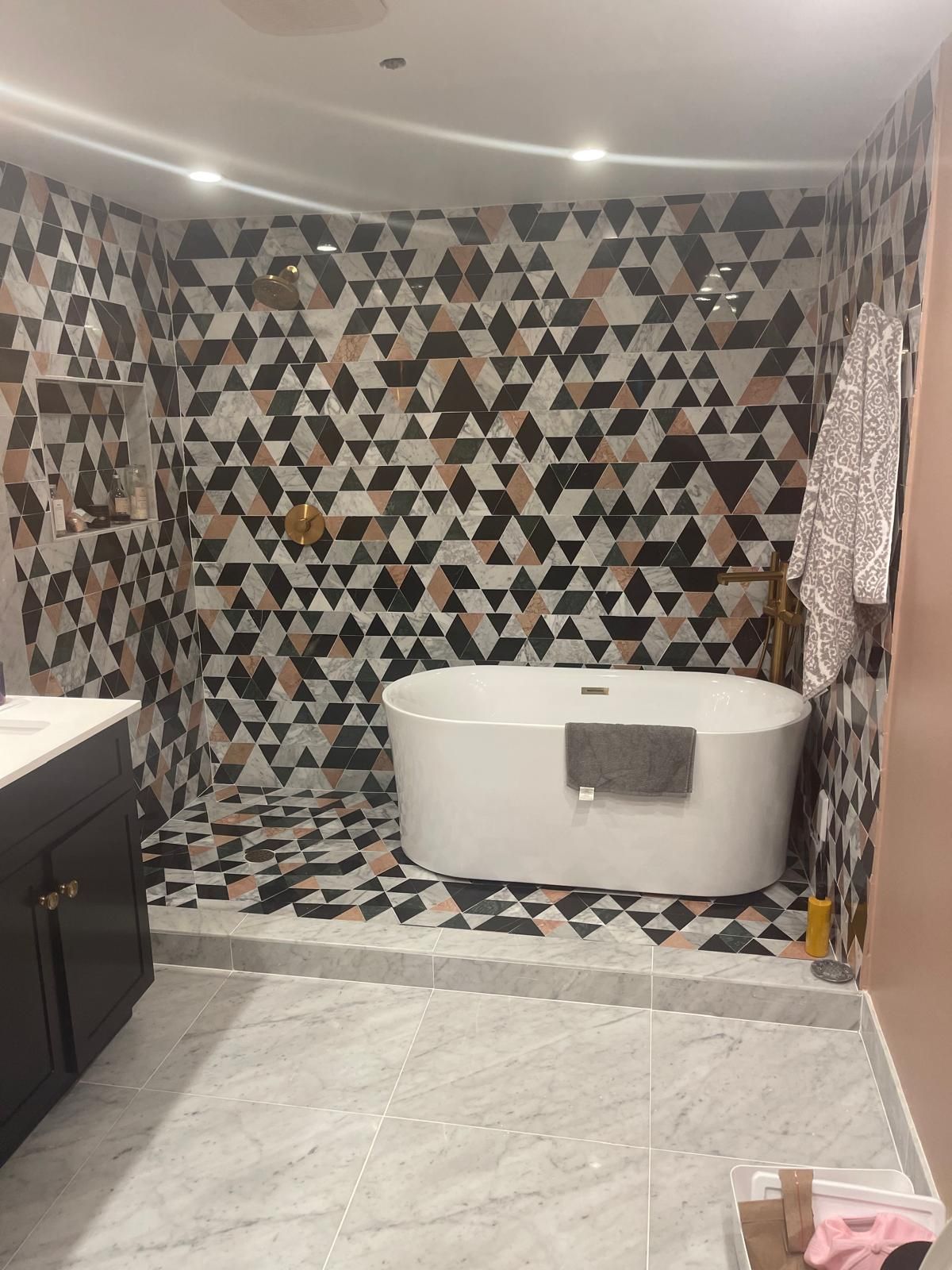 Geometric tile bathroom with freestanding tub