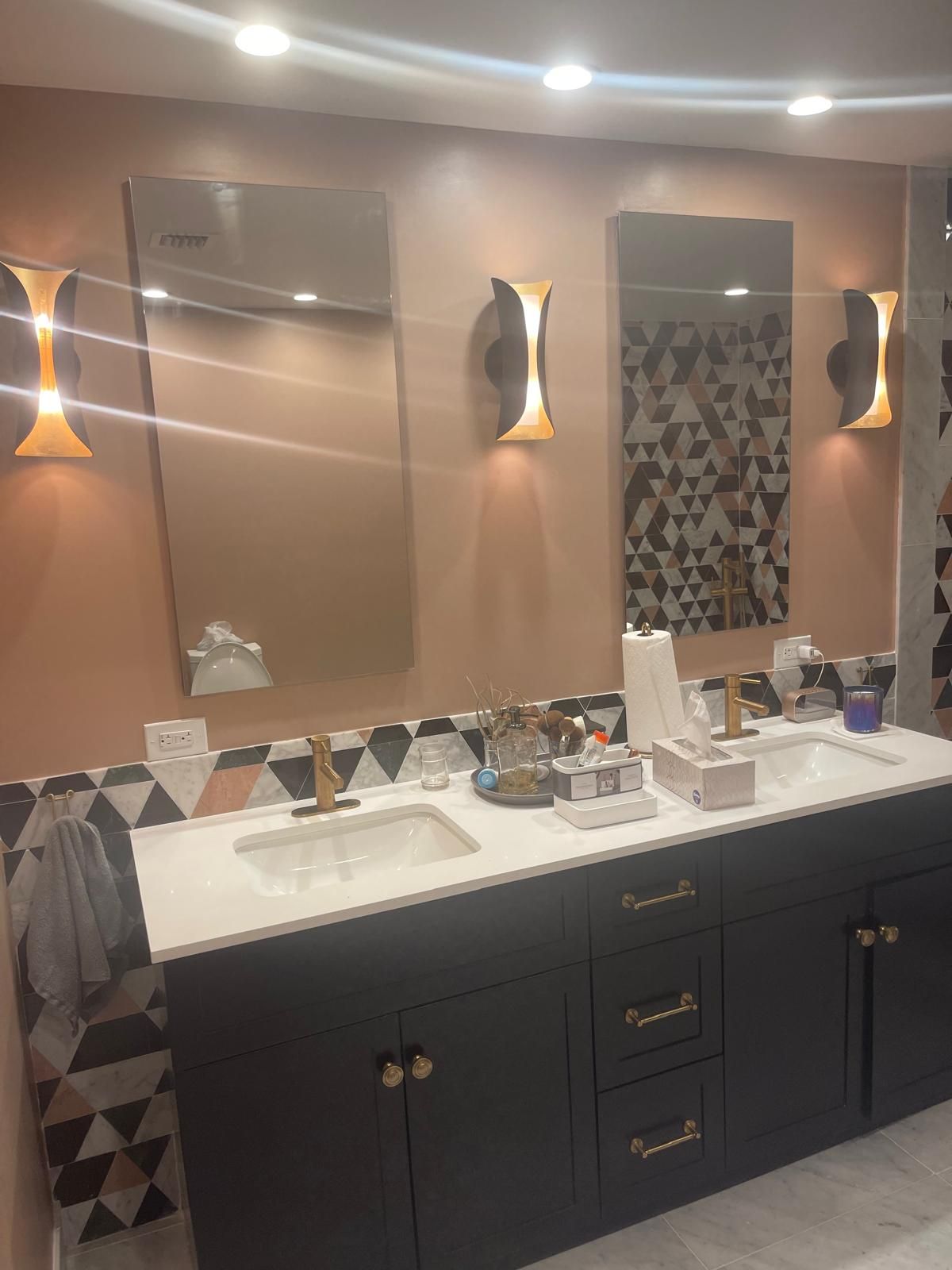 Modern bathroom with geometric tile and warm lighting