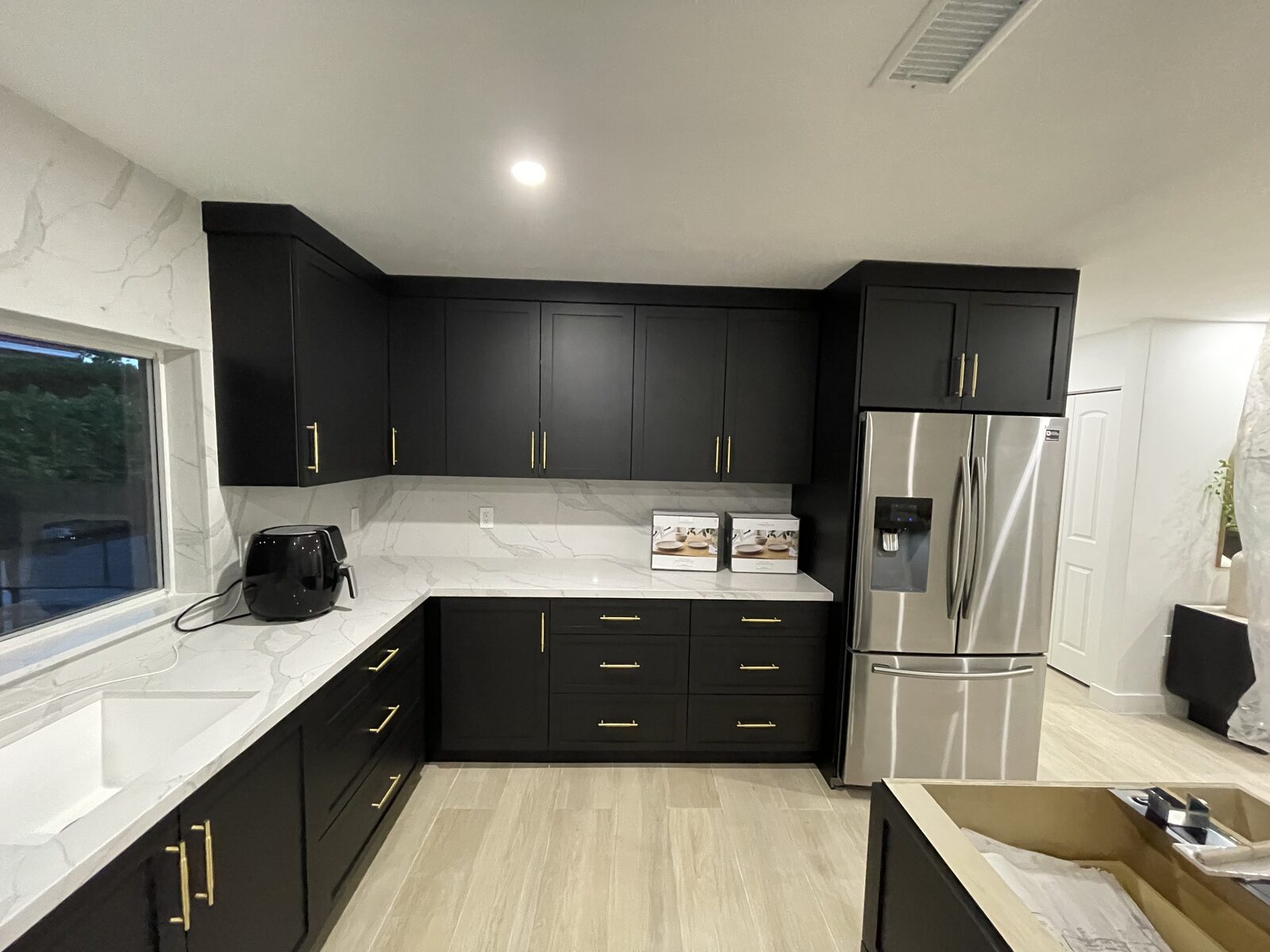 Dark shaker cabinets with white marble countertops