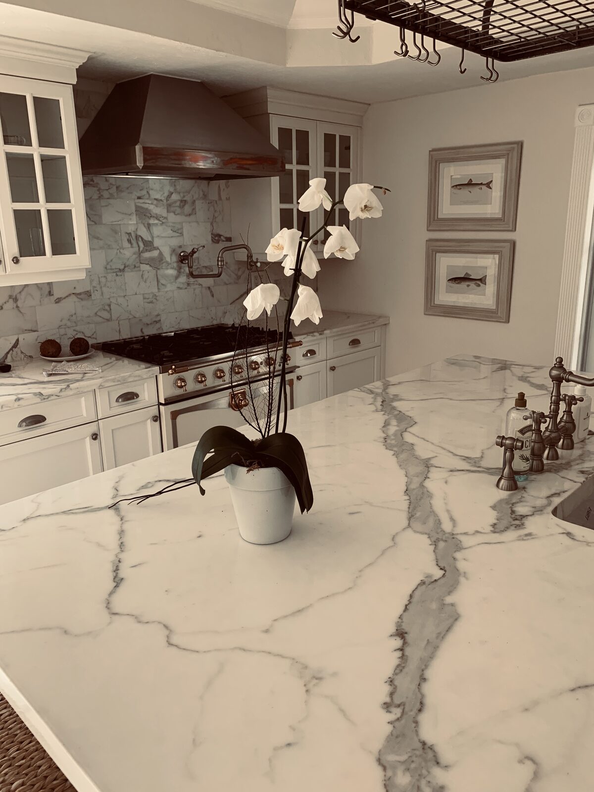 Luxury kitchen with copper range hood and marble island