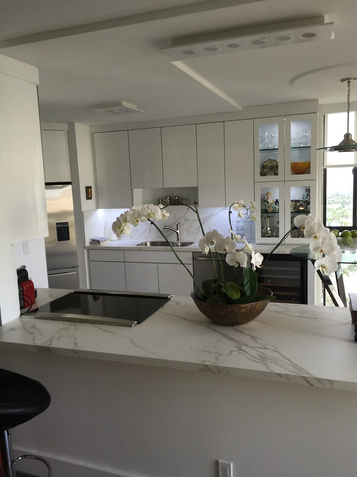 Modern kitchen with waterfall marble island and ocean view