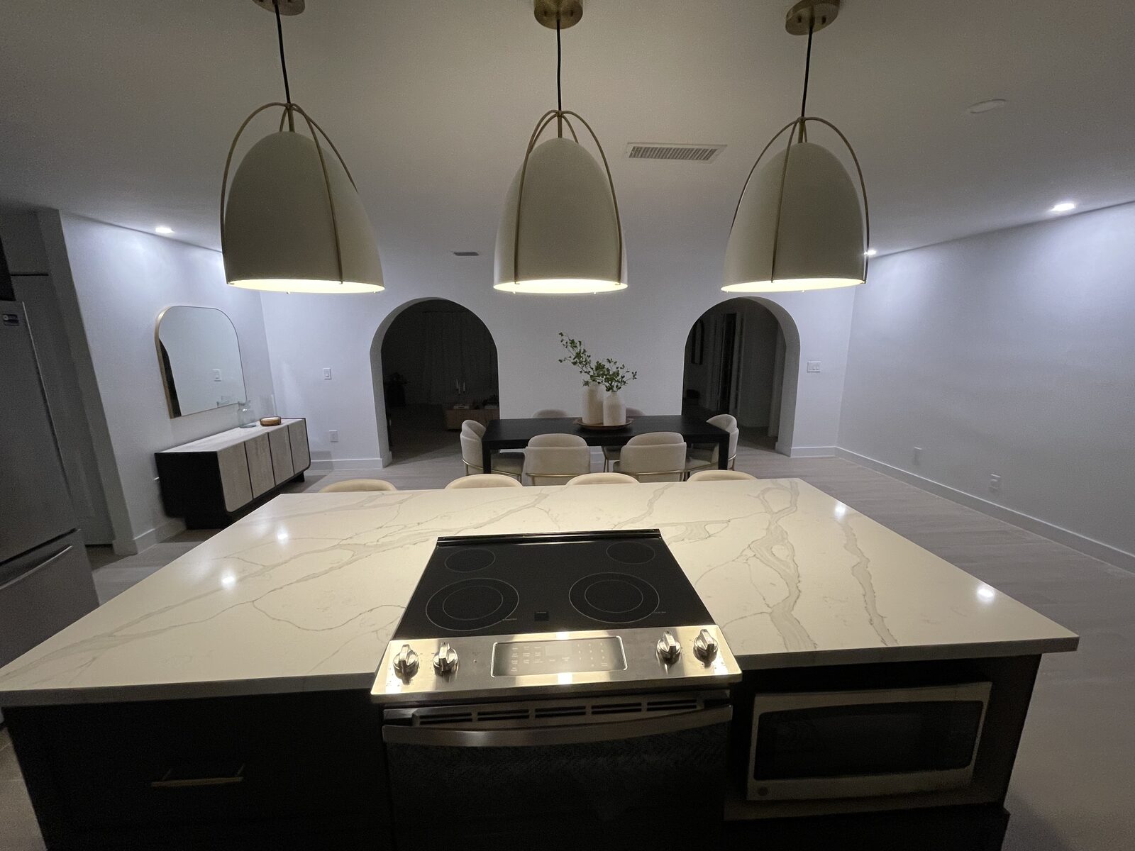 Kitchen with pendant lights and arched doorways