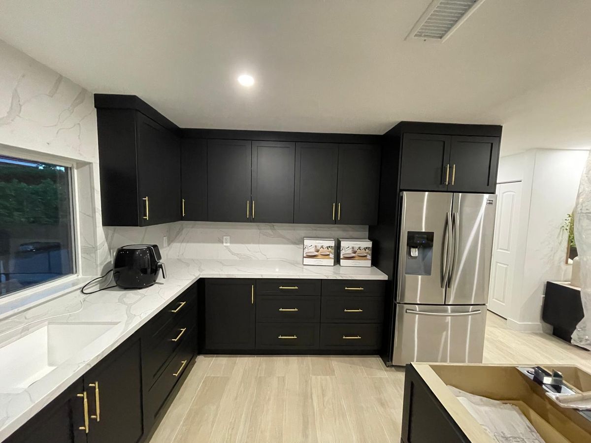 Modern kitchen with dark shaker cabinets and gold hardware