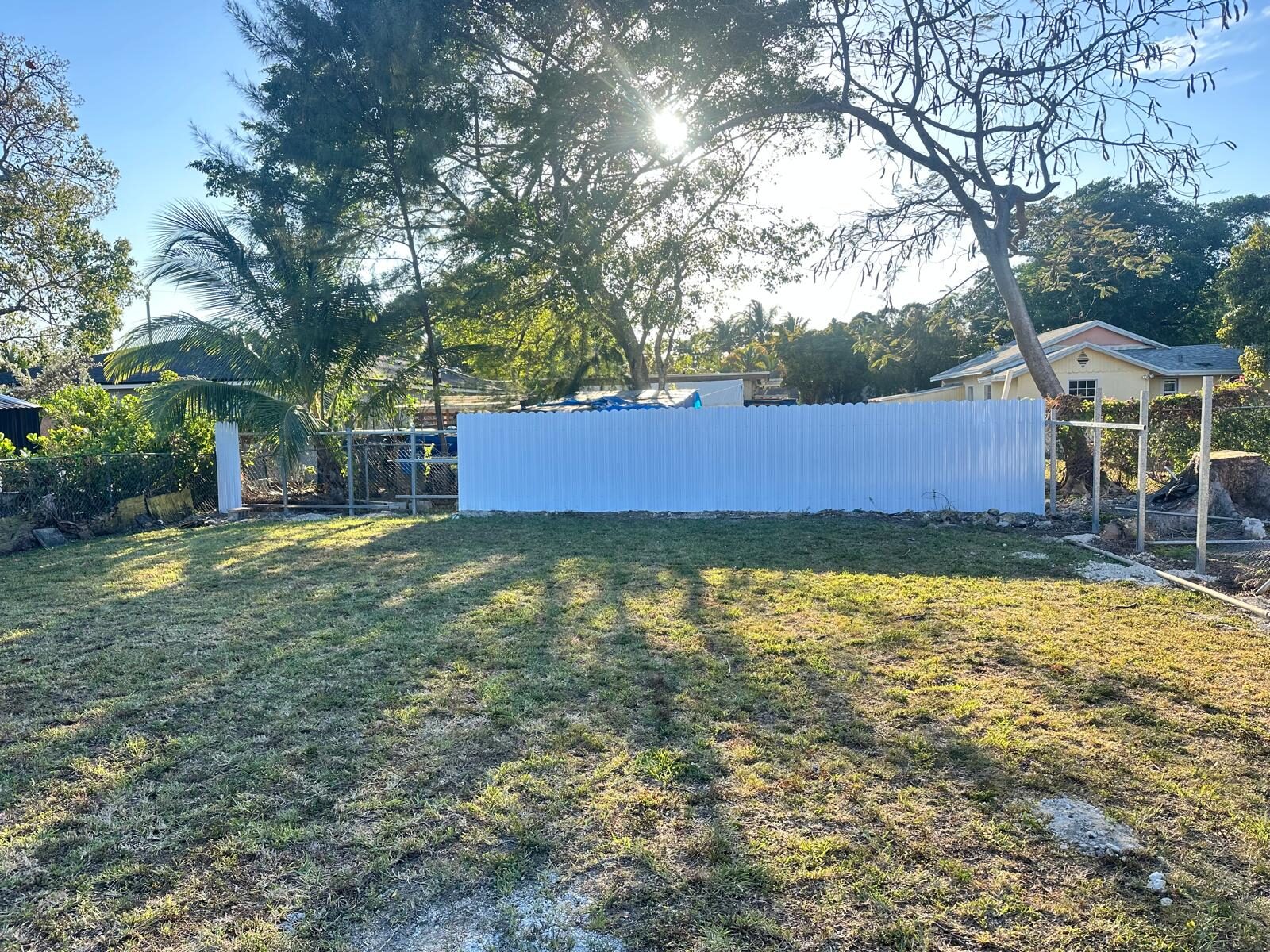 Backyard with new white privacy fence